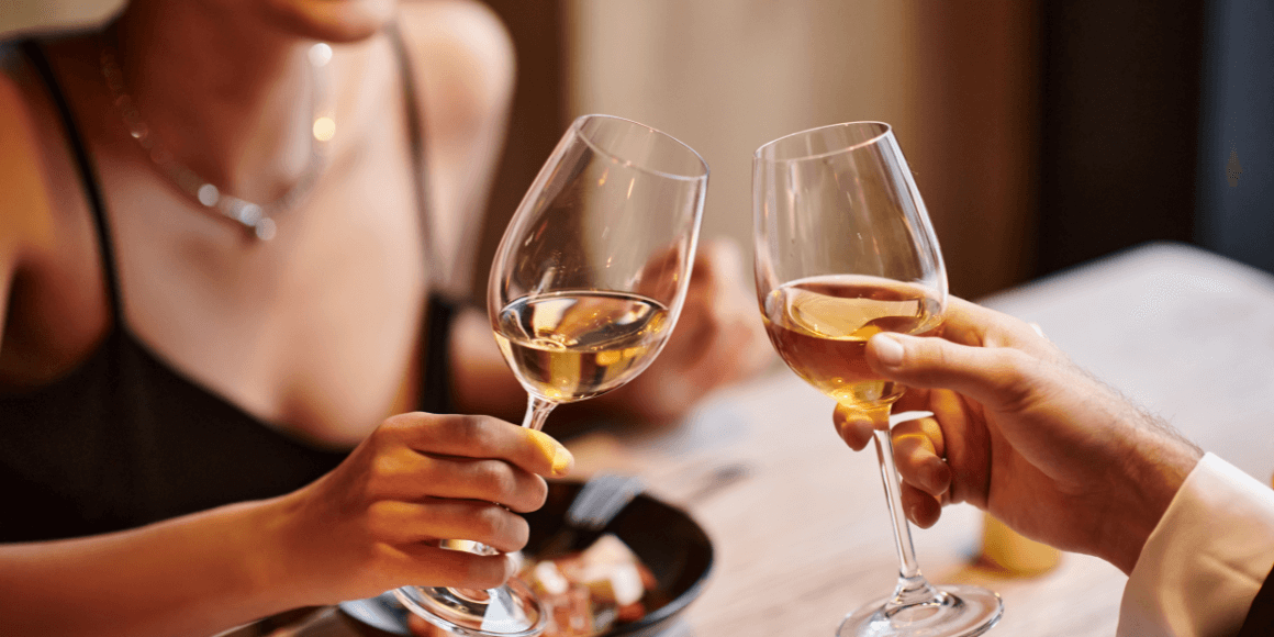 Couple toasting with wine during their at-home Valentine's dinner