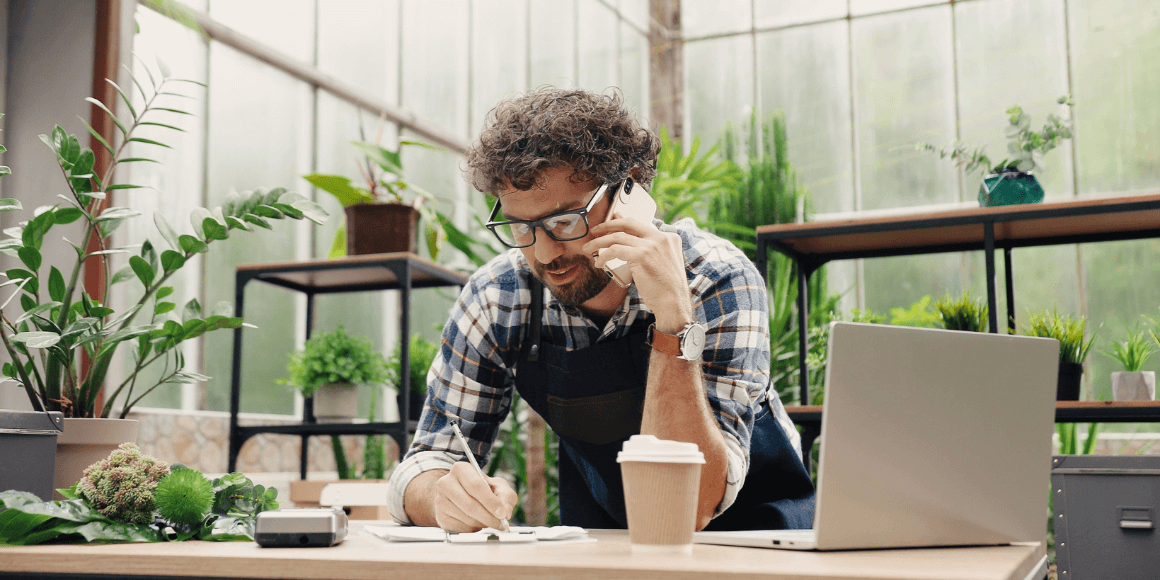 Small business owner talking on the phone while in their plant shop