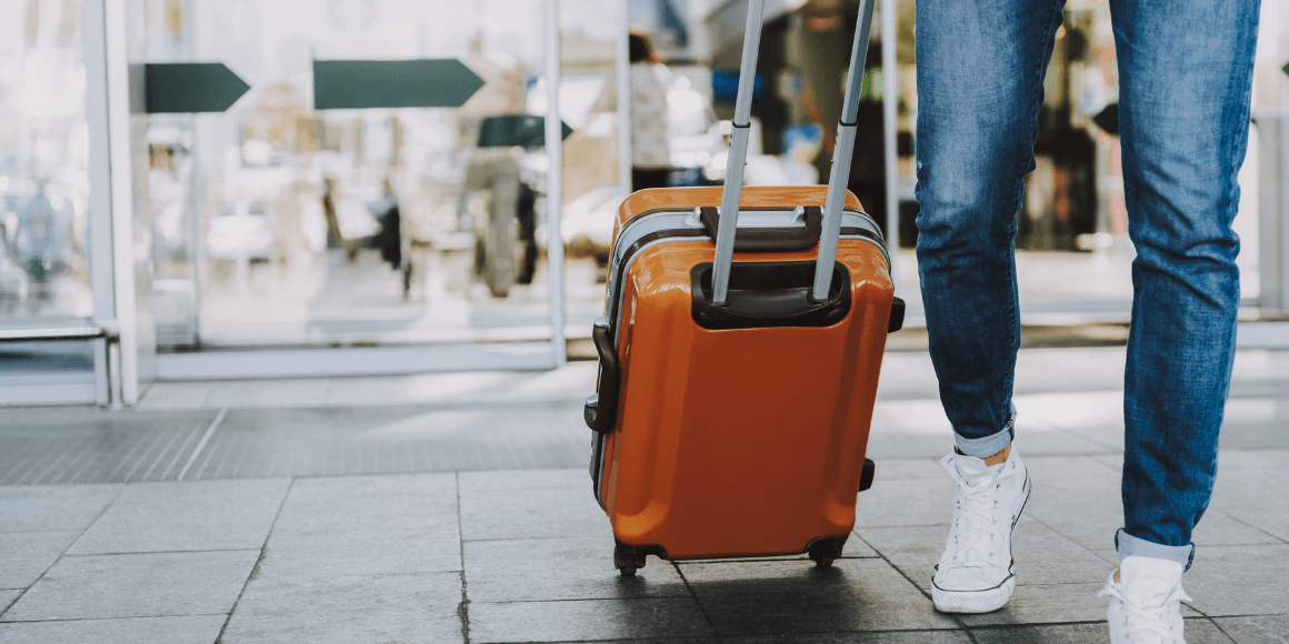 Traveler walking through an airport with their luggage