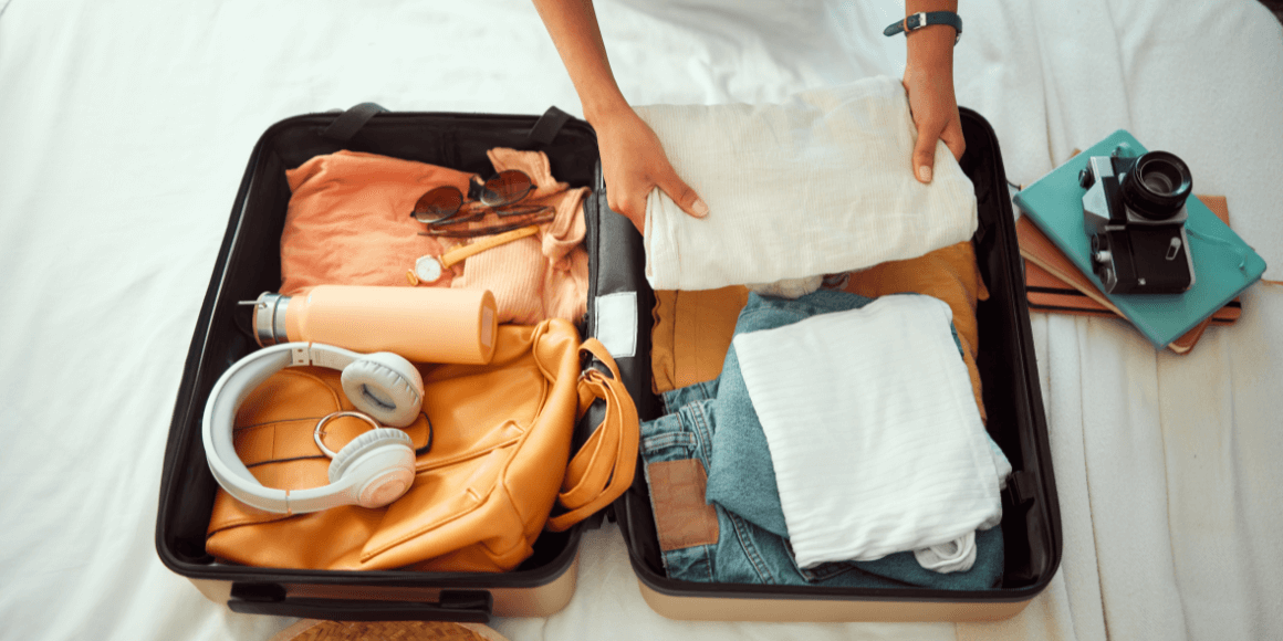 A woman preparing for vacation by packing her suitcase