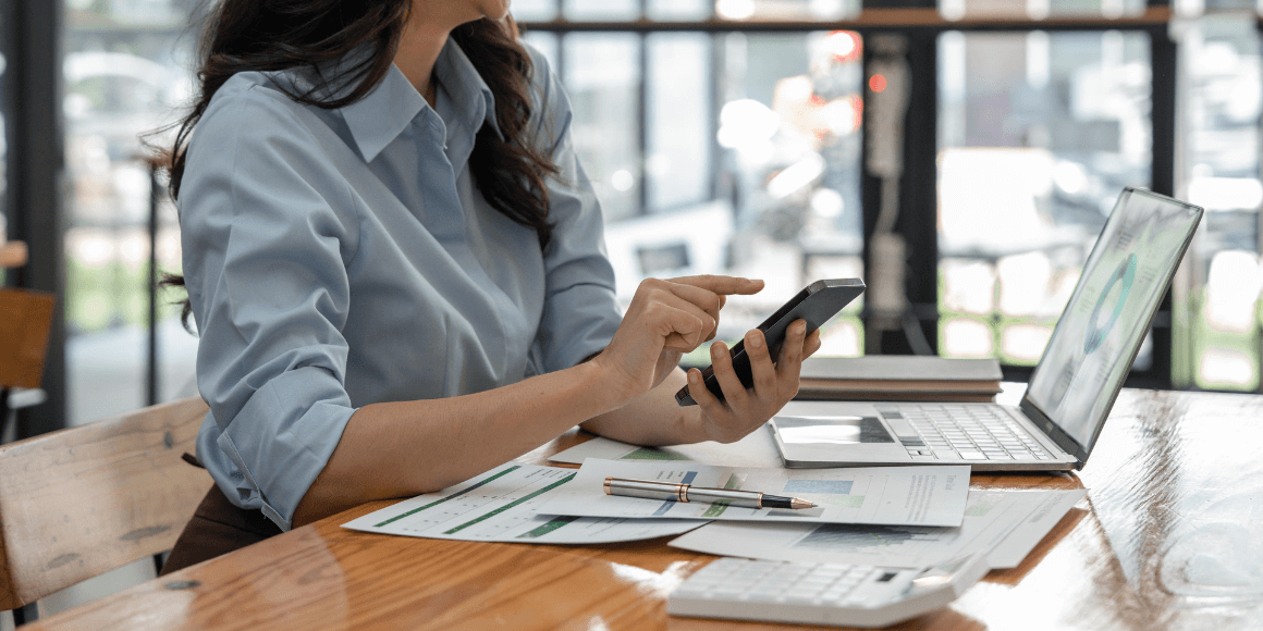 Woman sitting at a table and reviewing her finances 