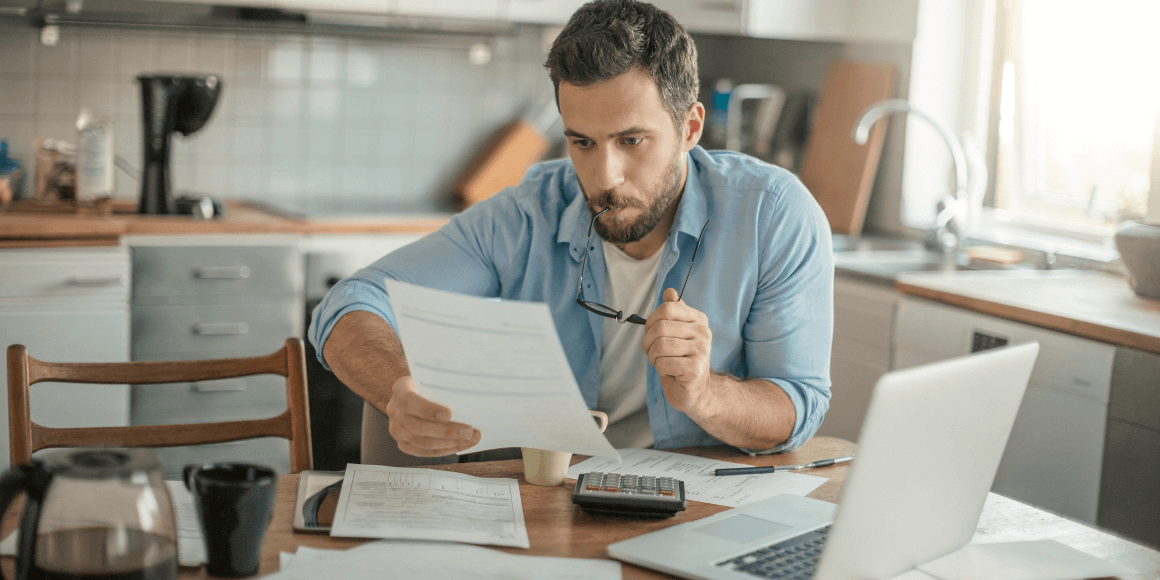 Man reviewing his bank statements and setting up his short term financial goals