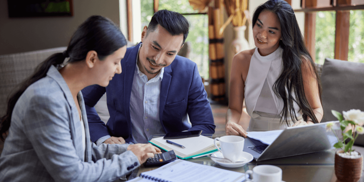 young couple meeting with a banker to discuss checking account options