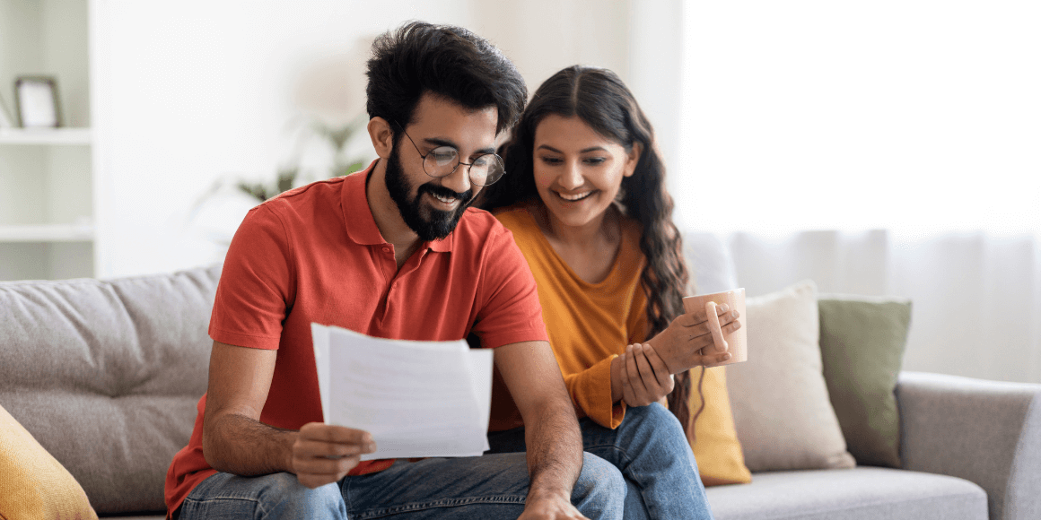 Happy young couple creating a financial plan for the year