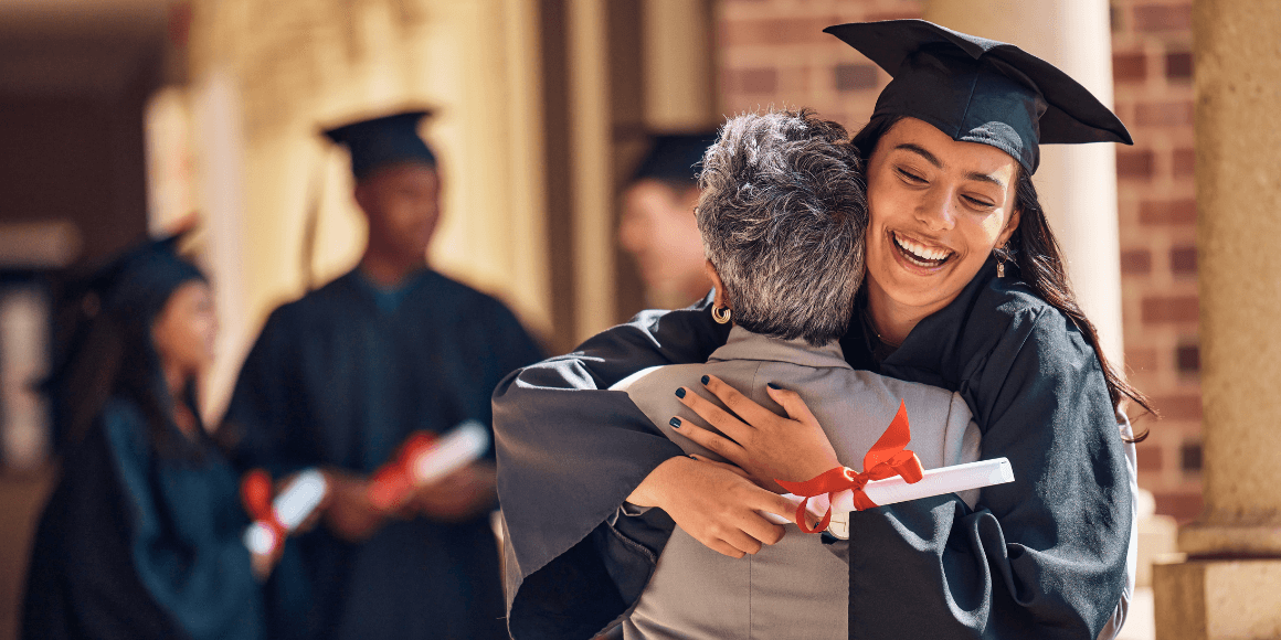 A happy college graduate hugging their mom