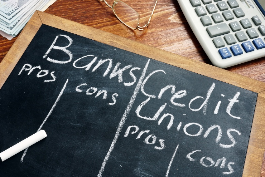 Pros and cons list of banks and credit unions written on a chalkboard