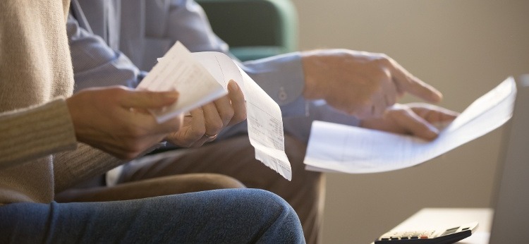 A couple sitting together and reviewing their expenses