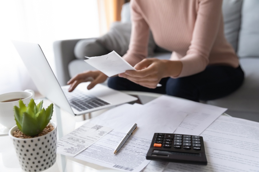 woman reviewing her savings and retirement accounts in her living room