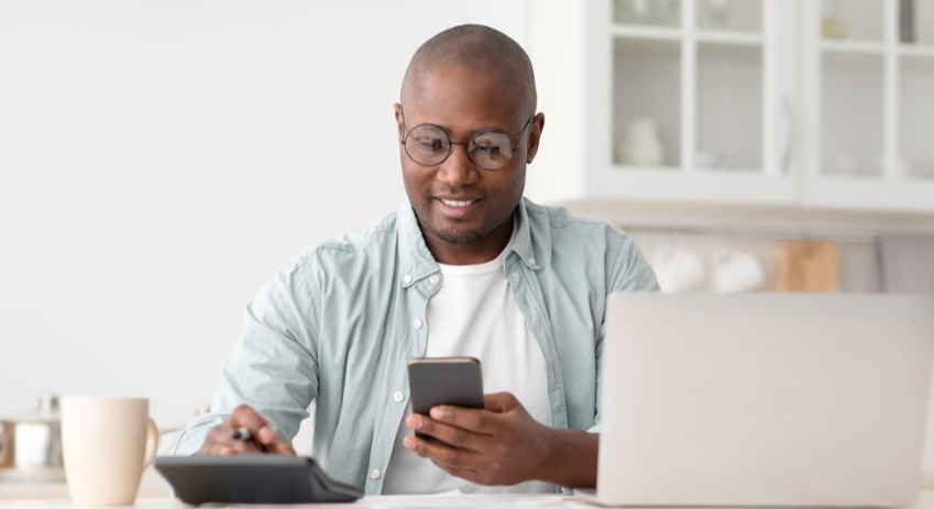 Young man using his phone to check his credit score