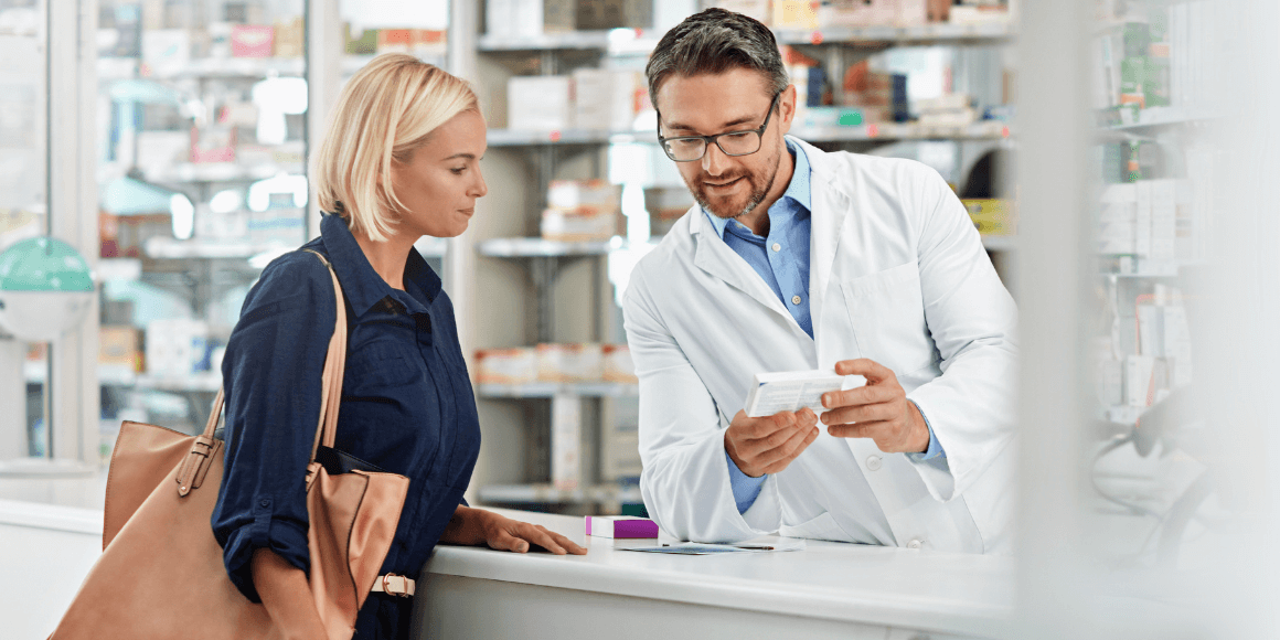 Woman speaking to a pharmacist about medication 