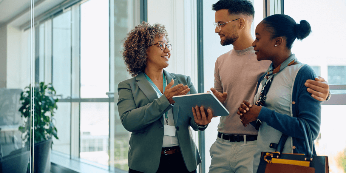 Young couple speaking to a banker about refinancing their loan