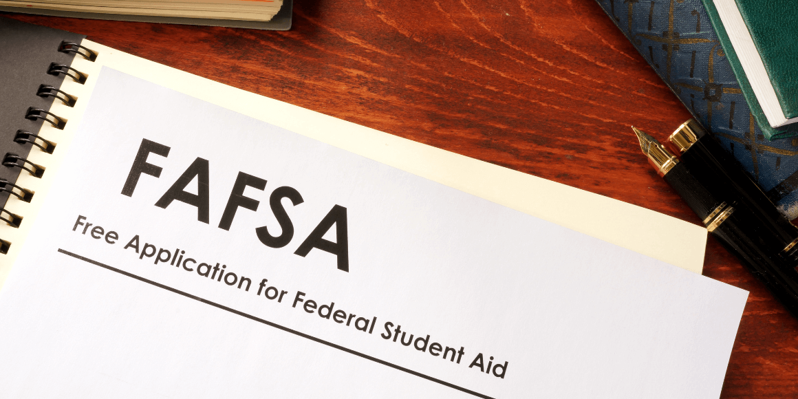 FAFSA form and notebooks placed on top of a table