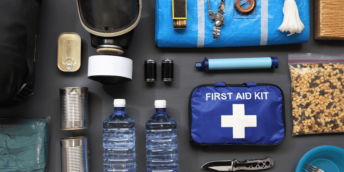 Emergency kit supplies laid out on a black table