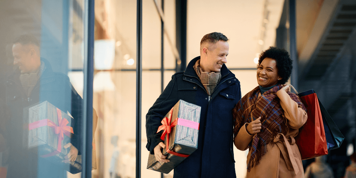 happy couple doing their last minute holiday shopping 