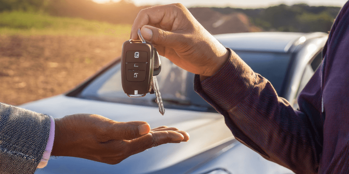 Shows a person buying a used car from the owner of the car