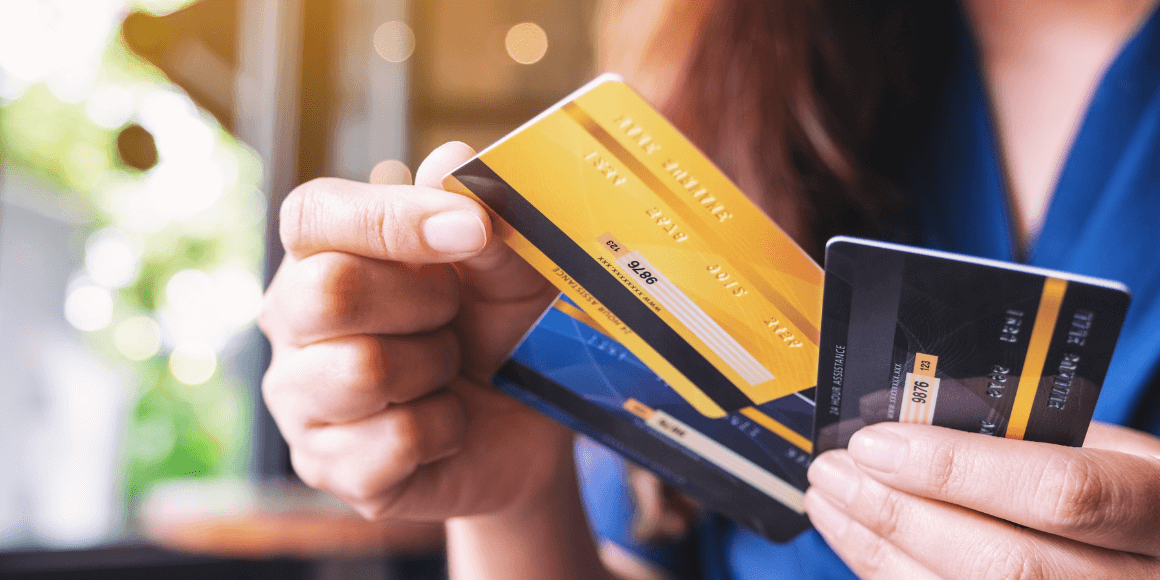 Woman holding three credit cards in her hands