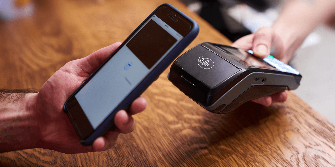 customer using their digital wallet to pay at the counter