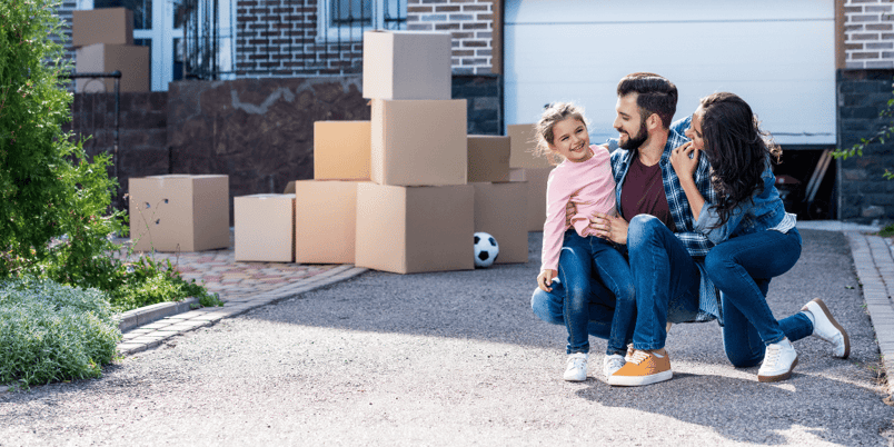 Smiling family moving into new home because they explored the best time of year to buy a house