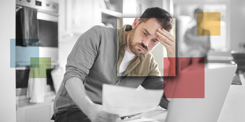Stressed man reviewing financial documents